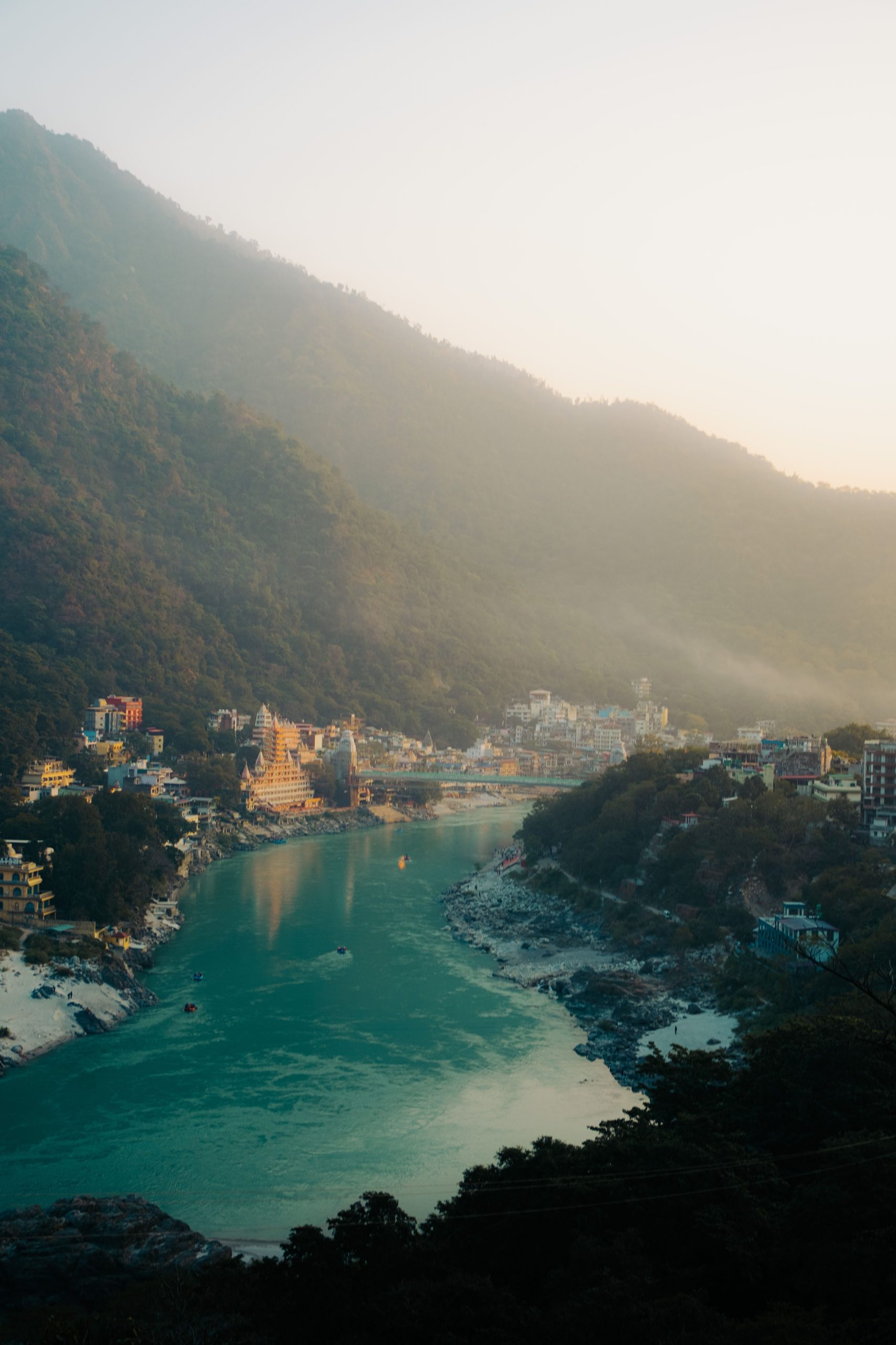 A breathtaking aerial view of Rishikesh with the Ganges River meandering through the landscape at sunrise.